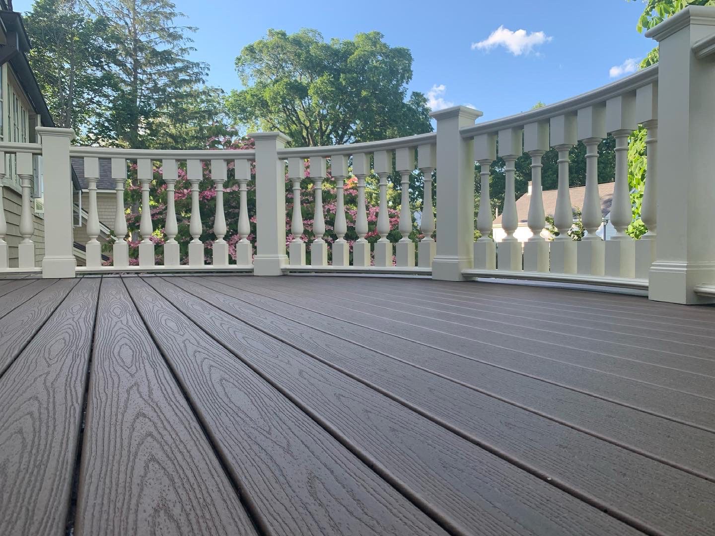 Trex composite decking on a rounded deck with a curved railing