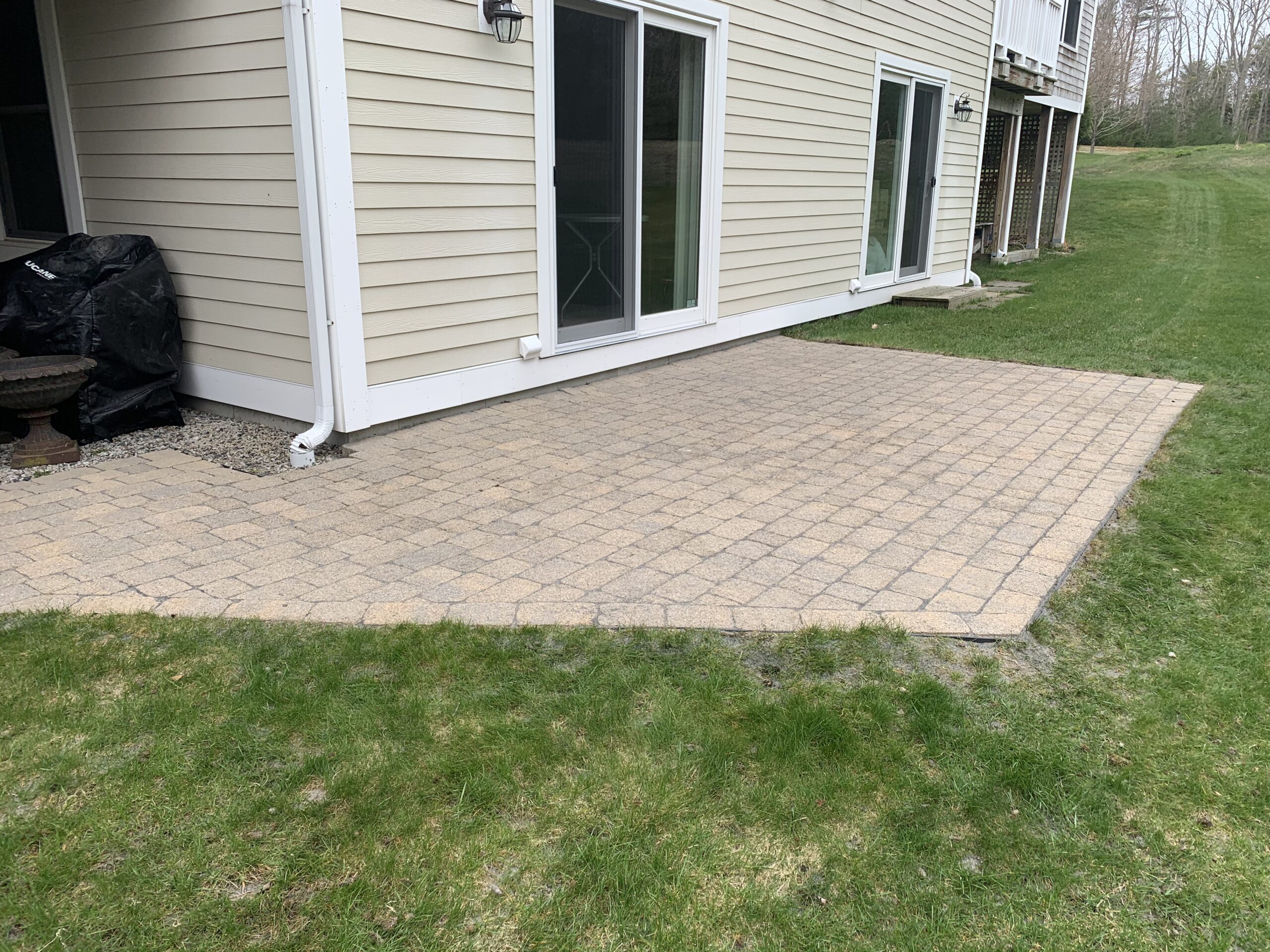 After cleaning, patio stones have been packed with polymeric sand, filling the gaps between paving stones.