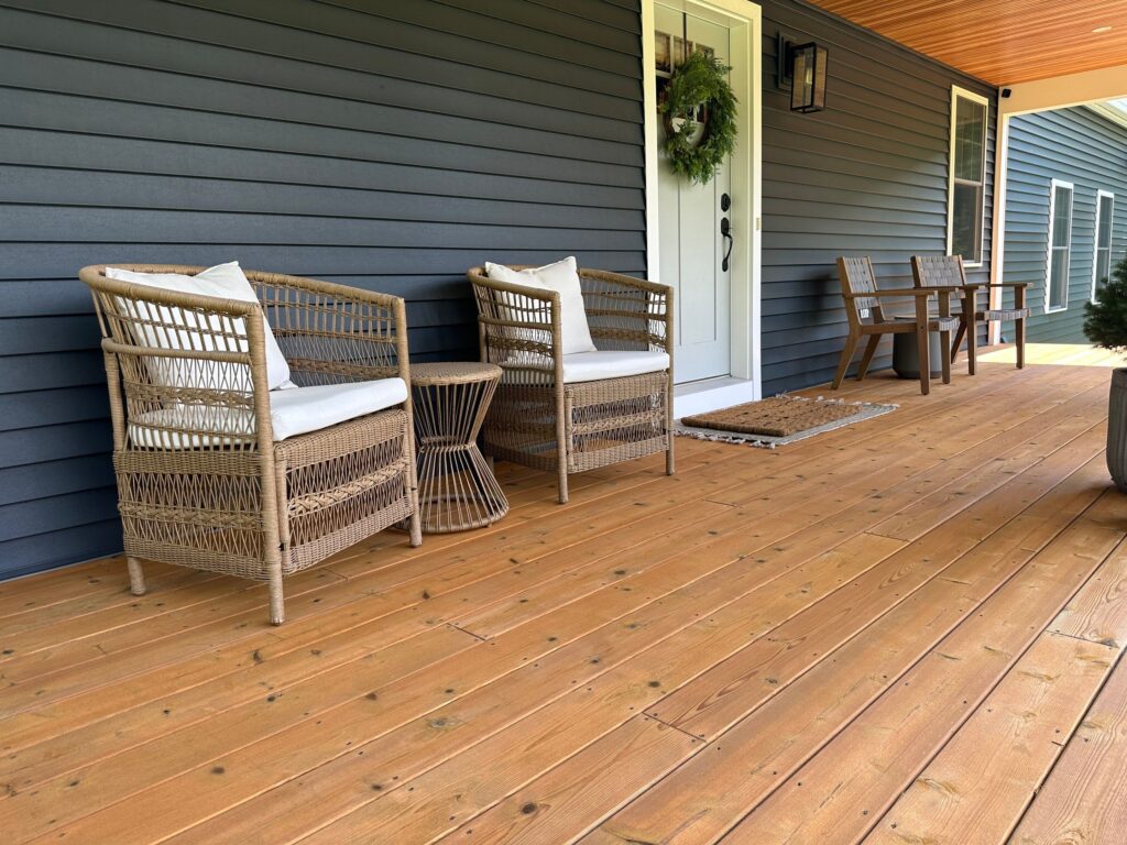 Some inviting wicker chairs on a freshly stained front porch
