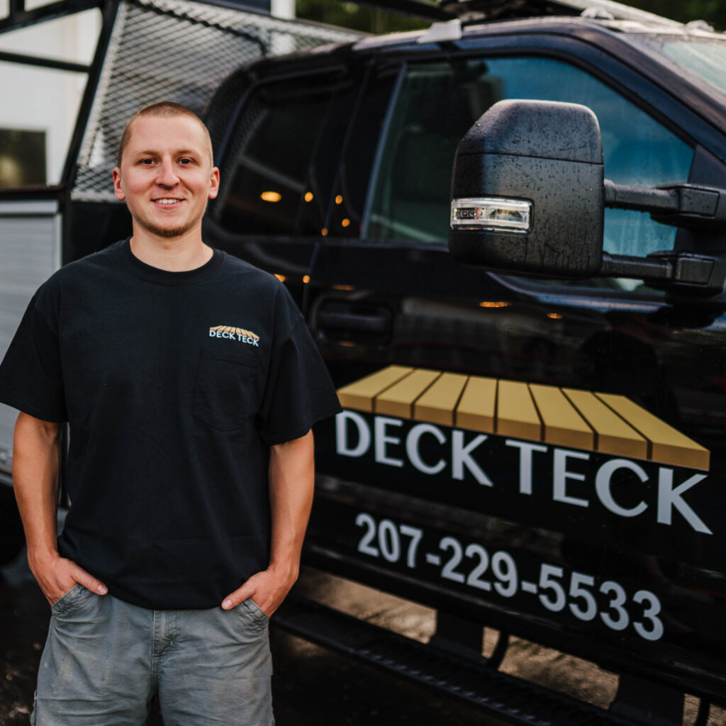 Owner Max McNally stands by one of Deck Teck's work trucks